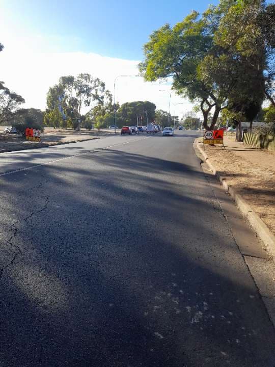 Roadwork signage on a tree-lined South Australian street